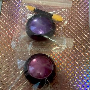 2 eyeshadows one magenta and the other a purple. Not opens or used